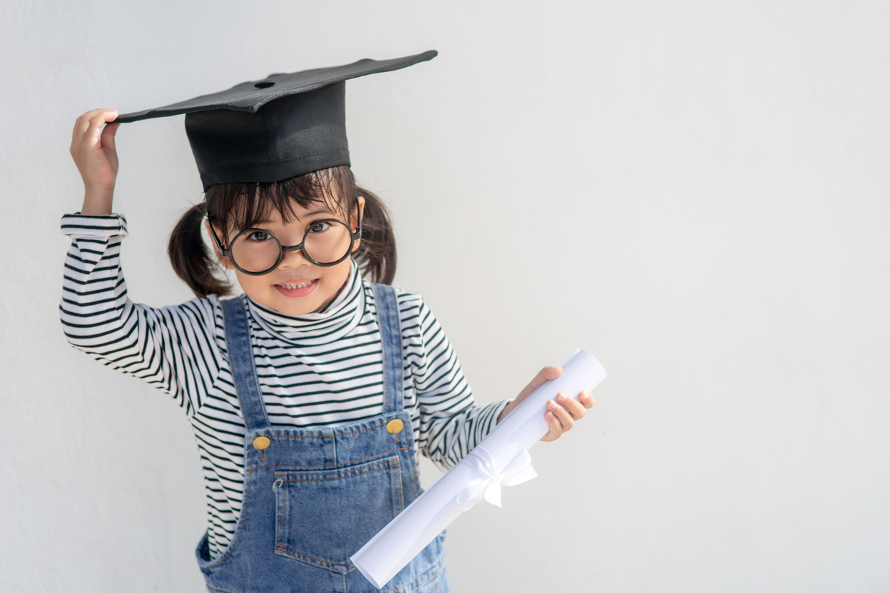 Happy Asian School Kid Graduate in Graduation Cap